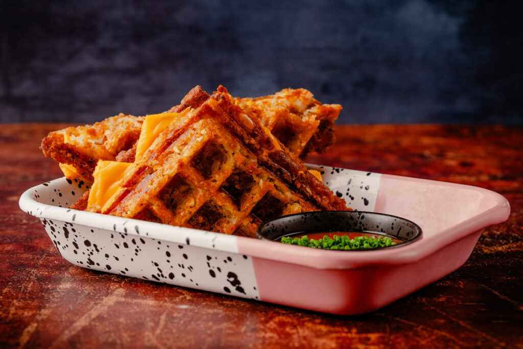 chicken-waffle-food-dallas-batbox.jpg A grilled cheese made with crispy golden hash brown waffles, a melty four-cheese blend, served with a spicy tomato dipping sauce.