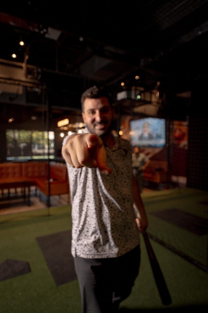 man-celebration-baseball-swing-simulator.jpg Man celebrating after a baseball swing at Batbox Dallas batting cage and hitting simulator.