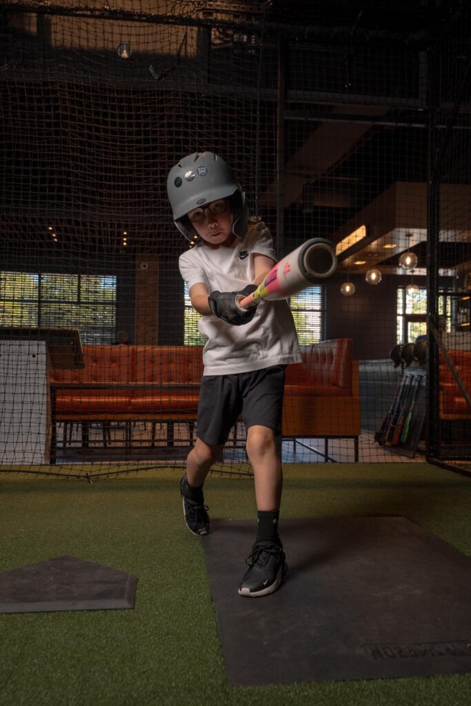 kids-baseball-birthday-party-dallas.jpg Kids enjoying a baseball birthday party at Batbox Dallas indoor sports entertainment venue