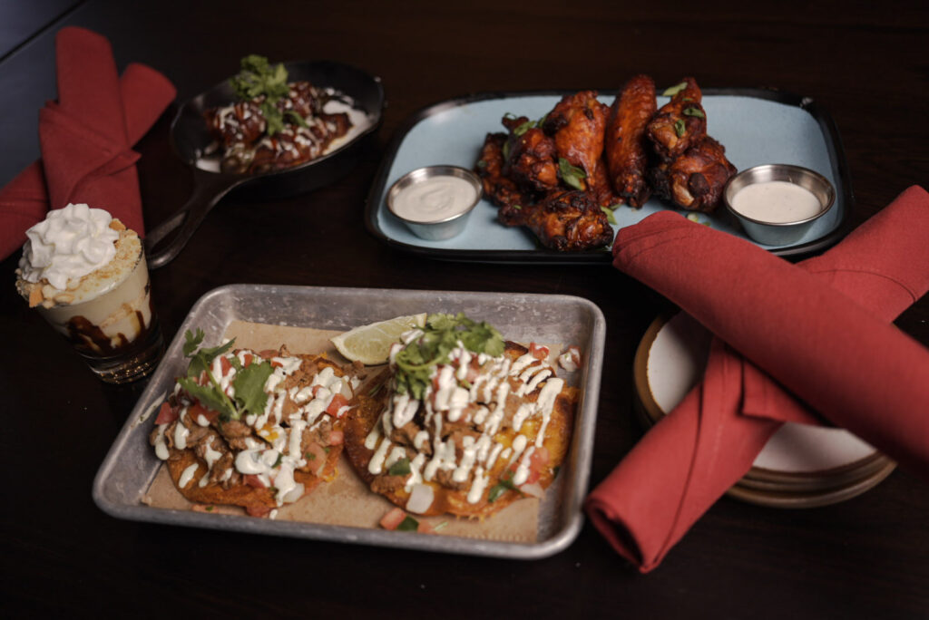 Hand crafted wings and dessert from the food menu at Batbox Dallas sports entertainment venue